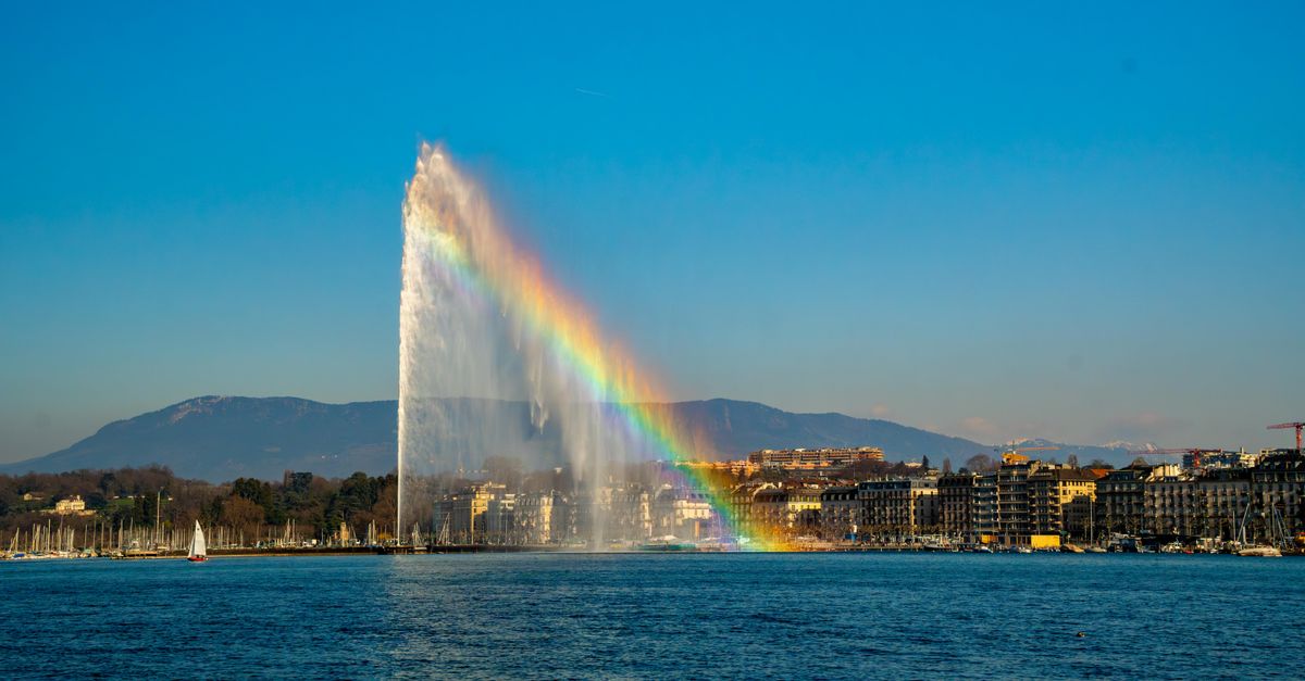 Stunning view of Jet d'Eau fountain with a rainbow over Lake Geneva in Switzerland.